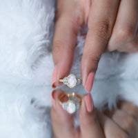 Vintage inspired opalescent oval engagement ring with a real diamond from Rosec Jewels displayed on a white background.