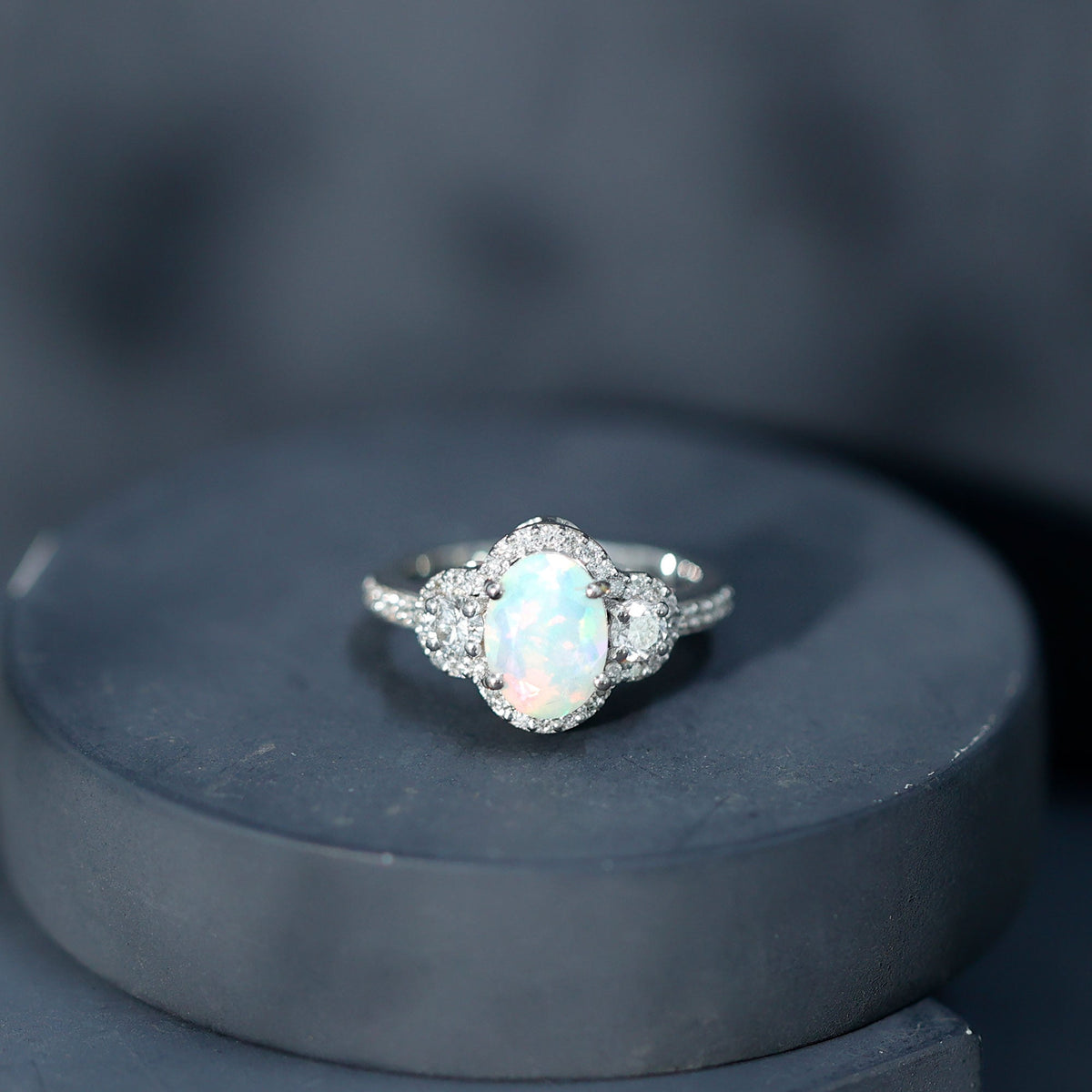 Vintage-inspired opalescent oval engagement ring with real diamond from Rosec Jewels, featuring a detailed silver band.