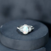 Vintage-inspired opalescent oval engagement ring with real diamond from Rosec Jewels, featuring a detailed silver band.