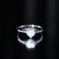 Heart-shaped Ethiopian opal engagement ring with diamond halo, featuring a rose gold band and intricate detailing.