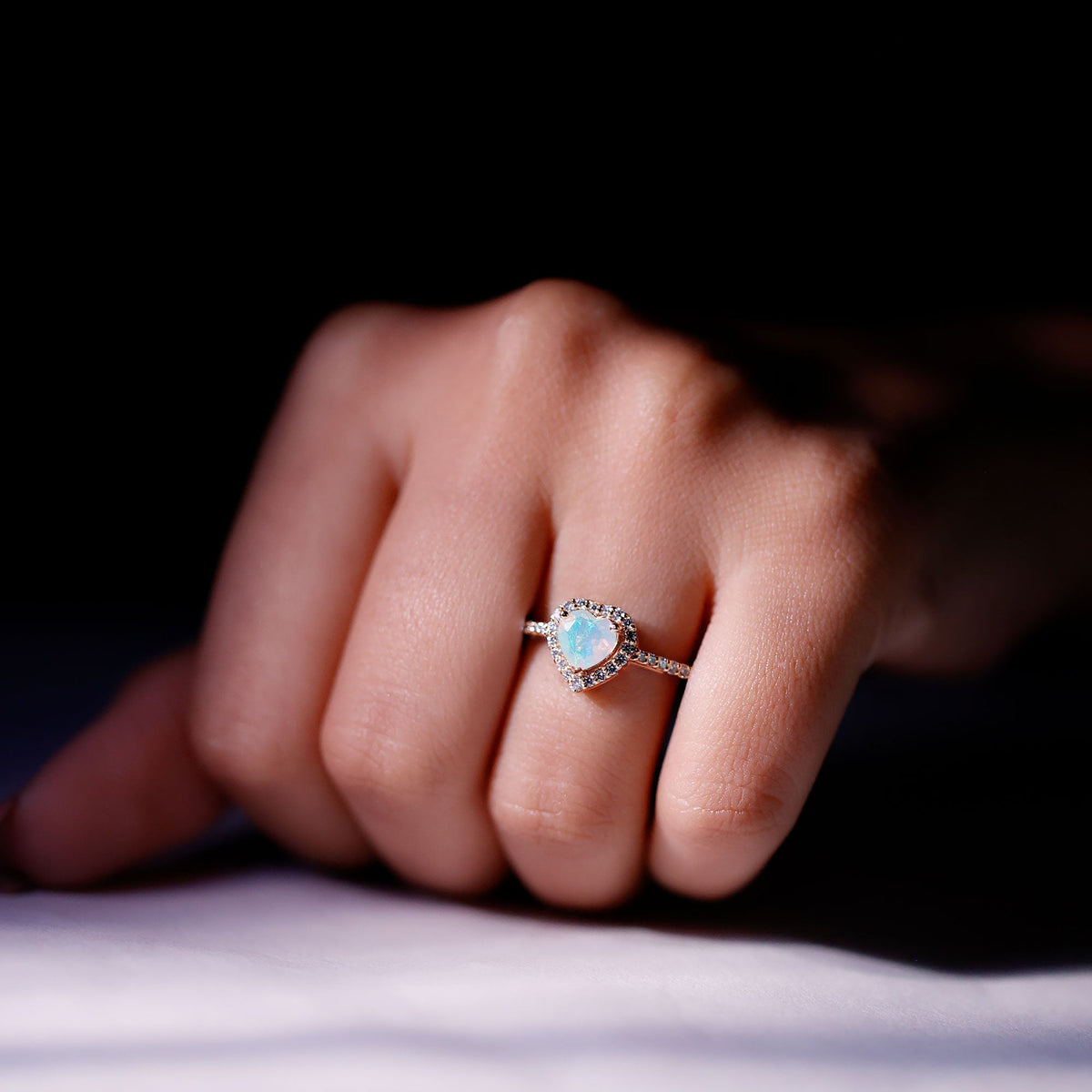 Heart-shaped engagement ring featuring natural Ethiopian opal with diamond halo setting, by Rosec Jewels.