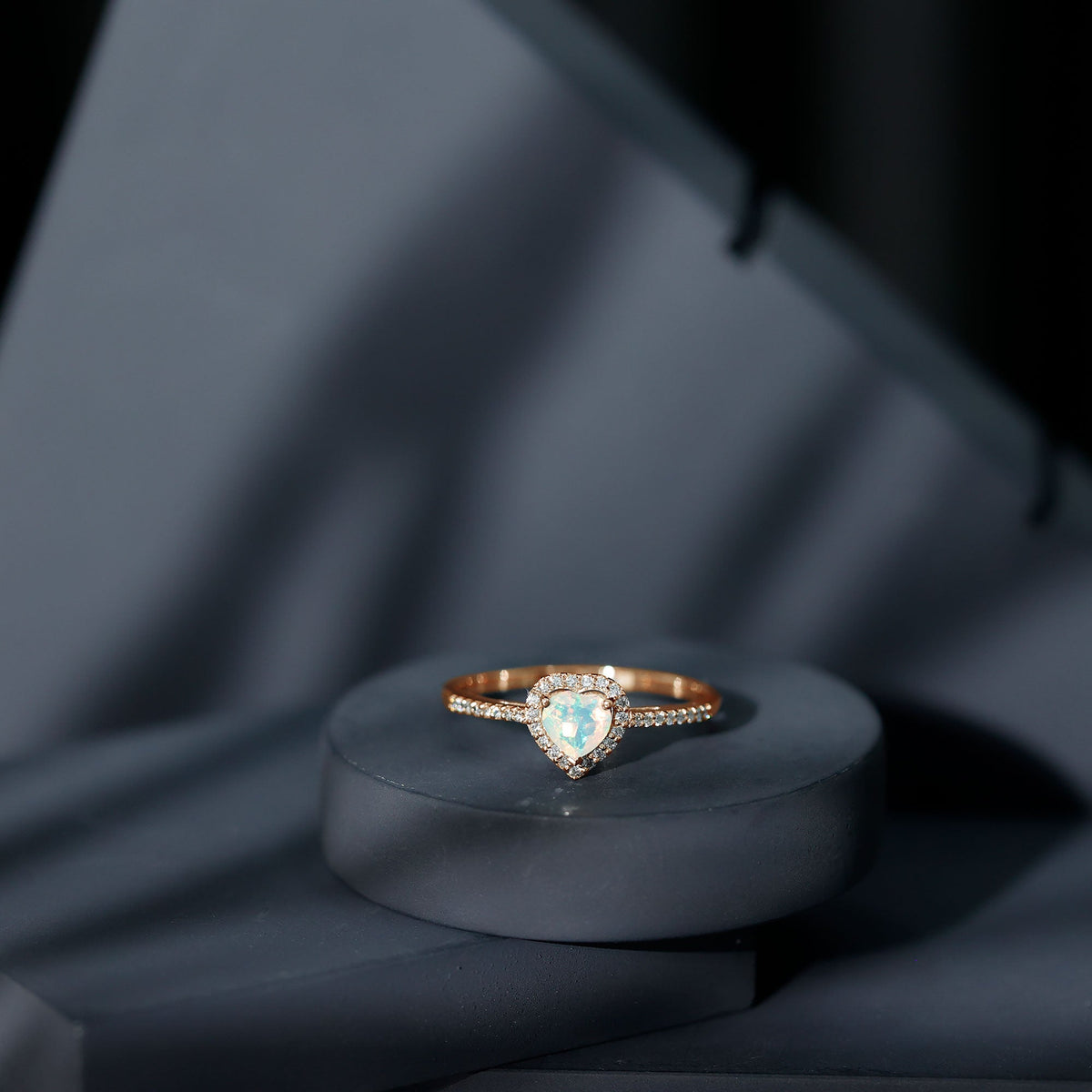 Heart-shaped Ethiopian opal engagement ring with diamond halo, featuring a rose gold band and intricate detailing by Rosec Jewels.