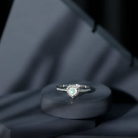 Heart-shaped Ethiopian opal engagement ring with diamond halo from Rosec Jewels, showcasing the colorful opal and sparkling diamonds.