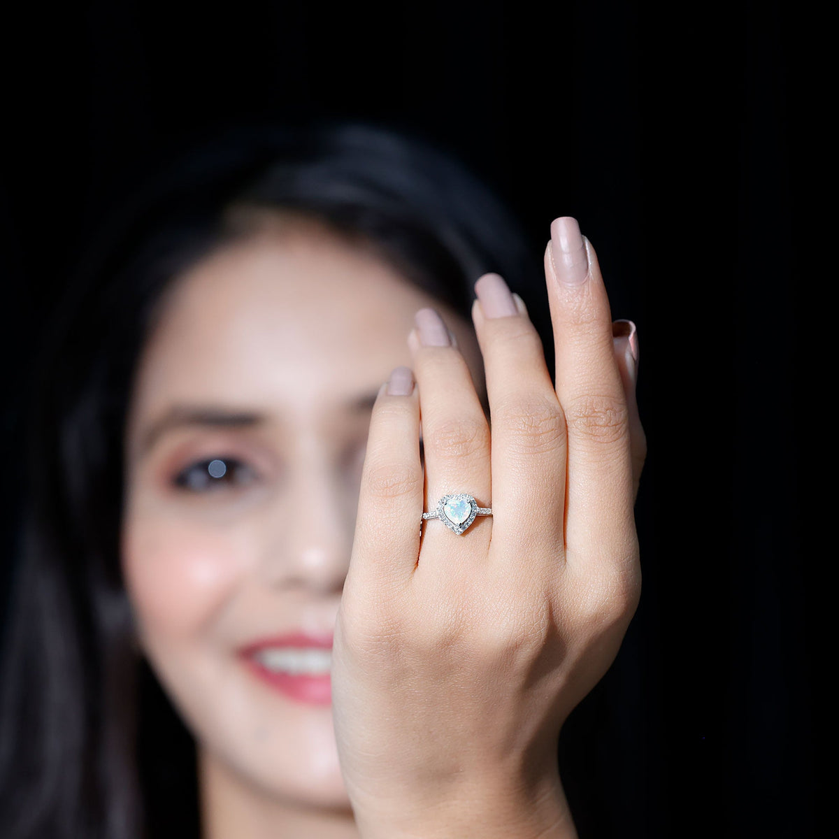 Heart-shaped Ethiopian opal engagement ring with diamond halo, featuring a rose gold band and intricate detailing.