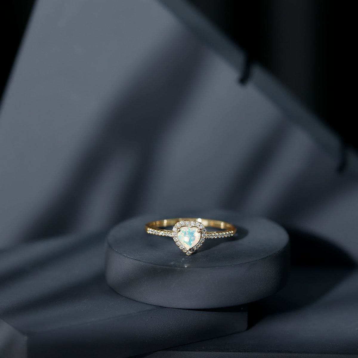 Heart-shaped Ethiopian opal engagement ring with diamond halo, crafted by Rosec Jewels, featuring vibrant gemstone and sparkling accents.