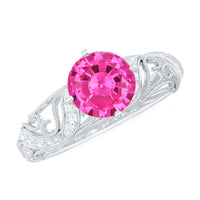 Lab grown pink sapphire antique engagement ring with diamond accents, showcasing intricate vintage design and rose gold band.