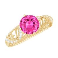 Lab-grown pink sapphire antique engagement ring with diamond accent, featuring intricate metalwork and vintage-inspired design.