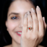 Flower-inspired fire opal engagement ring with diamonds from Rosec Jewels, showcasing a vibrant fire opal centerpiece and delicate floral design.