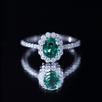 Certified 1.2 carat oval lab-grown emerald halo engagement ring with yellow gold band by Rosec Jewels.