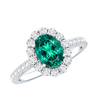 Oval lab-grown emerald halo engagement ring with diamond accents from Rosec Jewels displayed in the image.