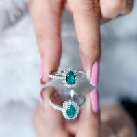 Oval lab-grown emerald halo engagement ring with diamond accents in a Rosec Jewels ring setting, showcasing intricate craftsmanship.