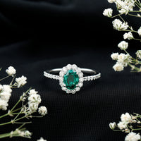 Oval lab-grown emerald halo engagement ring with diamond accents by Rosec Jewels, showcasing the detailed design and sparkling stones.