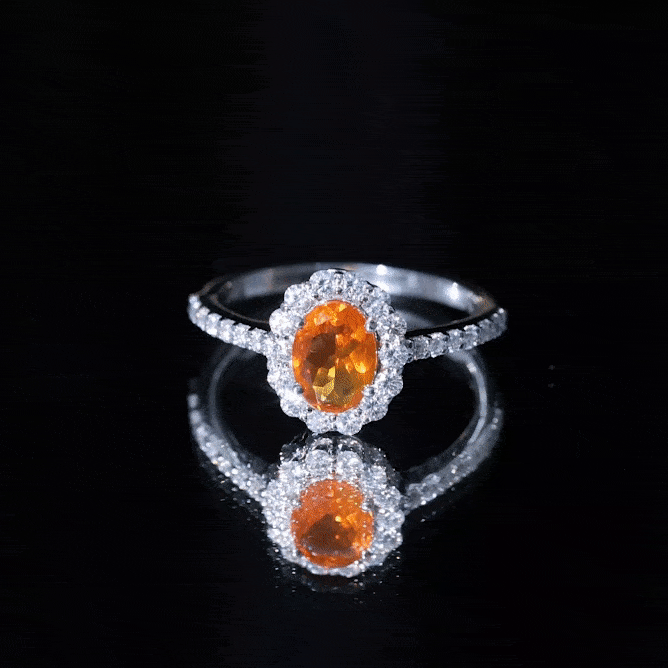 Orange fire opal oval engagement ring with moissanite accents by Rosec Jewels, showcasing the vibrant gemstone and elegant band.