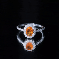 Orange fire opal oval engagement ring with moissanite accents by Rosec Jewels, showcasing the vibrant gemstone and elegant band.