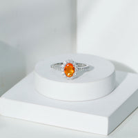 Orange fire opal oval engagement ring with moissanite accents by Rosec Jewels, showcasing a vibrant gemstone and elegant design.
