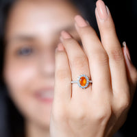 Orange fire opal oval engagement ring with moissanite accents from Rosec Jewels, showcasing a stunning gemstone and elegant band design.