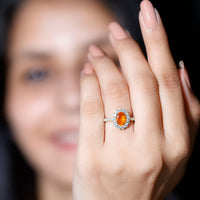 Orange fire opal oval engagement ring with moissanite from Rosec Jewels, showcasing a vibrant gemstone set in a delicate silver band.
