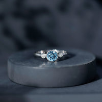 Bezel set aquamarine and diamond engagement ring from Rosec Jewels with certificate, showcasing the detailed design and gemstones.