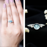 Bezel set aquamarine engagement ring with diamonds by Rosec Jewels, featuring a central aquamarine gemstone and sparkling accents.