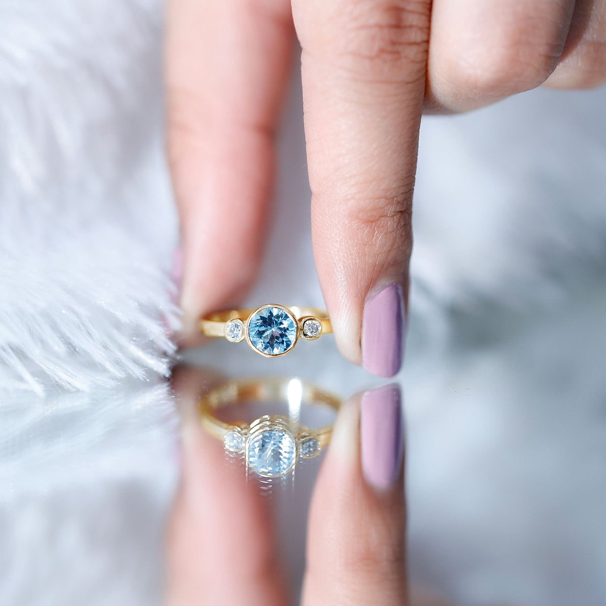 Bezel set aquamarine and diamond engagement ring by Rosec Jewels with certificate, showcasing the sparkling gemstone and elegant band.
