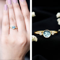 Bezel set aquamarine and diamond engagement ring by Rosec Jewels featuring a central aquamarine gemstone and sparkling diamonds.