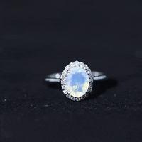 Oval Ethiopian Opal engagement ring with diamond halo by Rosec Jewels, showcasing the elegant ring design and sparkling stones.