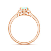 Natural Ethiopian opal oval engagement ring with diamond halo from Rosec Jewels, showcasing the shimmering opal and sparkling diamonds.