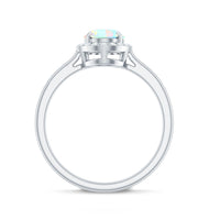 Natural Ethiopian opal oval engagement ring with diamond halo from Rosec Jewels, showcasing the elegant ring design and sparkling gemstones.