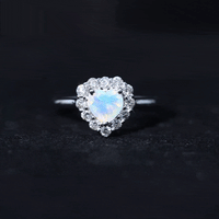 Heart-shaped engagement ring with certified Ethiopian opal and diamond halo by Rosec Jewels, showcasing a sparkling gemstone setting.