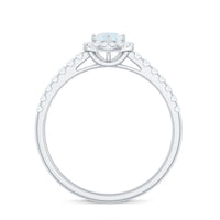 0.75 CT moonstone and diamond halo engagement ring featuring a rose gold band, showcasing intricate design and sparkling gemstones.