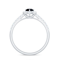 Minimal black spinel engagement ring with diamond halo from Rosec Jewels, featuring a sleek black spinel centerpiece and sparkling halo.