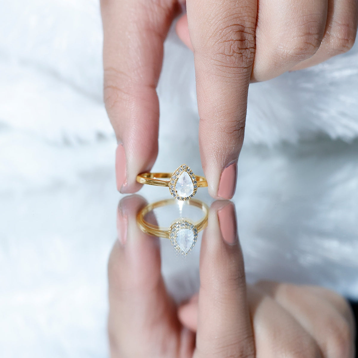 Pear-shaped moonstone halo engagement ring with diamond accents from Rosec Jewels, showcasing the elegant design and sparkling details.