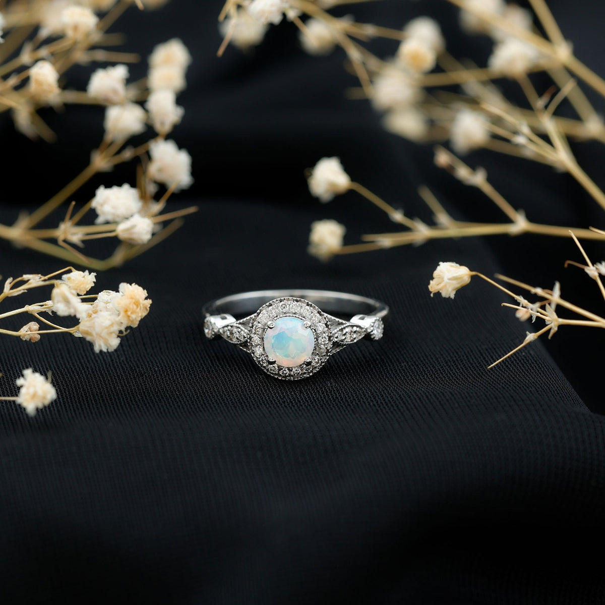 Antique-style Ethiopian opal engagement ring with diamond halo from Rosec Jewels, featuring a vibrant, oval-shaped opal centerpiece.