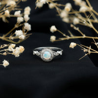 Antique-style Ethiopian opal engagement ring with diamond halo from Rosec Jewels, featuring a vibrant, oval-shaped opal centerpiece.