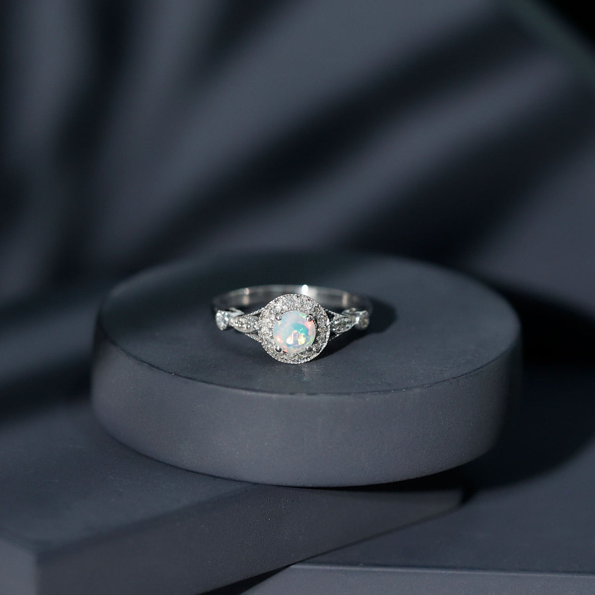 Antique-style engagement ring with genuine Ethiopian opal and diamond halo, featuring a vintage design from Rosec Jewels.