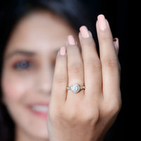 Genuine Ethiopian Opal antique-style engagement ring with diamond halo, featuring intricate metalwork and a vibrant central stone.
