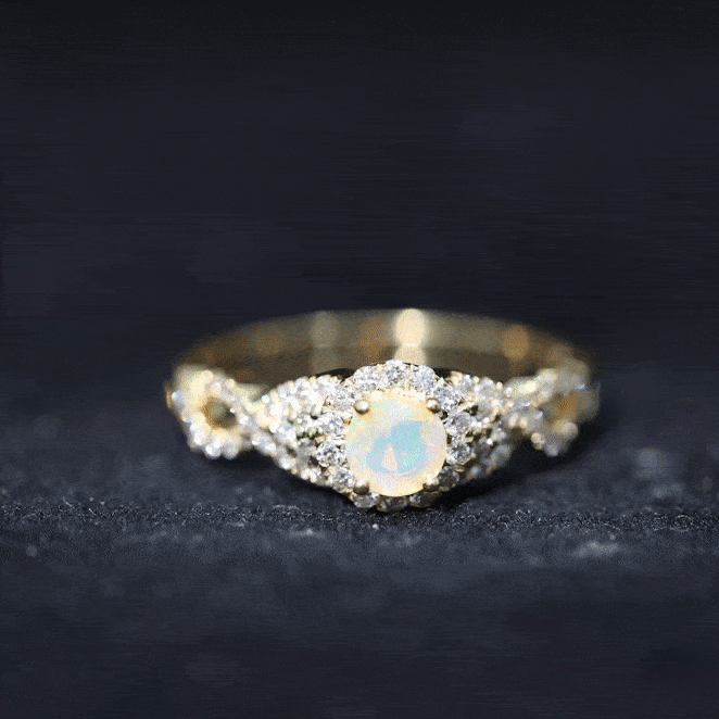 Vintage-style engagement ring with real Ethiopian opal center stone, diamond accents, and a criss-cross shank by Rosec Jewels.