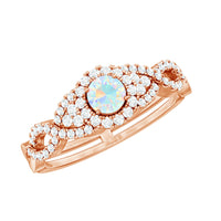 Vintage-style engagement ring with Ethiopian opal and diamonds, featuring a criss-cross shank design by Rosec Jewels.