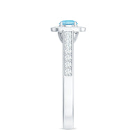 Vintage aquamarine and diamond halo engagement ring for women featuring a central aquamarine gemstone and intricate metalwork.
