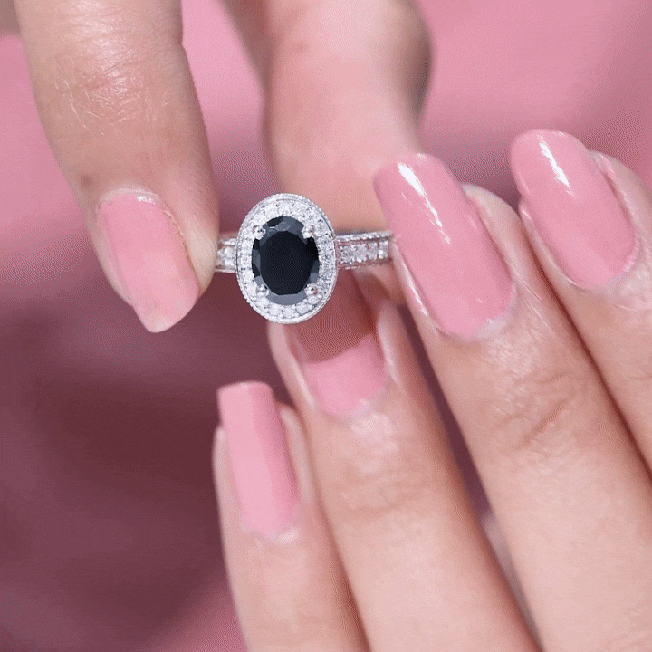 Vintage-inspired black onyx oval engagement ring by Rosec Jewels featuring a diamond halo setting.