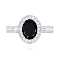 Vintage-inspired black onyx oval engagement ring with diamond halo, featuring a silver band and intricate detailing from Rosec Jewels.
