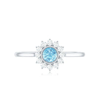 Round aquamarine and diamond halo promise ring by Rosec Jewels, showcasing a central aquamarine with surrounding diamond accents.