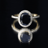 Lab-grown black and white diamond oval engagement ring with halo, crafted by Rosec Jewels, featuring sparkling stones and intricate design.