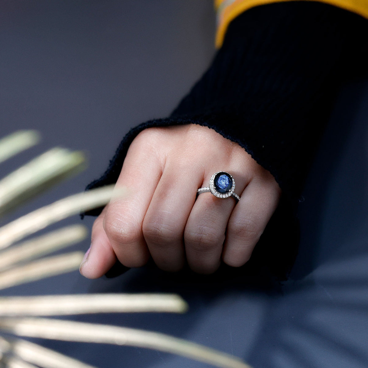 Lab grown black and white diamond oval engagement ring with halo by Rosec Jewels, showcasing sparkling stones and elegant design.