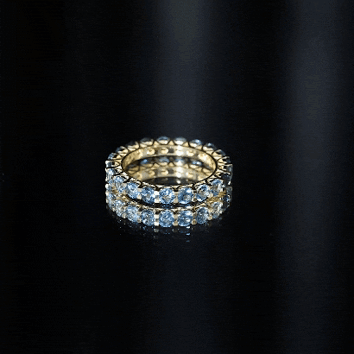 Rosec Jewels London Blue Topaz full eternity band ring featuring a continuous row of vibrant blue topaz gemstones.