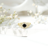 Vintage-looking Rosec Jewels 1.3 Carat lab-grown black diamond engagement ring with white diamond accents, elegant and unique design.