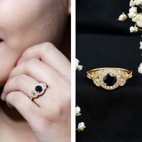Vintage-looking 1.3 carat lab-grown black diamond engagement ring with white diamond accents, featuring intricate metalwork and rose gold finish.