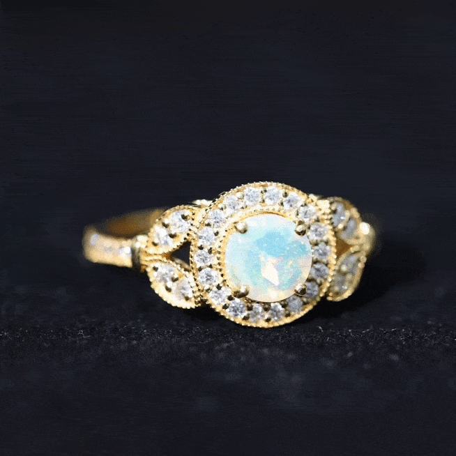 Vintage-inspired Ethiopian rainbow opal engagement ring with diamond halo, showcasing colorful gemstone and elegant design.