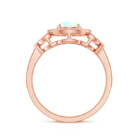 Vintage-inspired Ethiopian rainbow opal engagement ring with diamond halo, showcasing a stunning colorful center stone and sparkling accents.