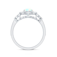 Vintage Ethiopian Rainbow Opal engagement ring with diamond halo from Rosec Jewels, showcasing colorful opal and sparkling diamond accents.